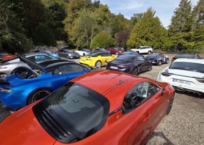 Alpine et voitures de sport stationnées lors de la pause de la Ronde des Fermes et des Châteaux